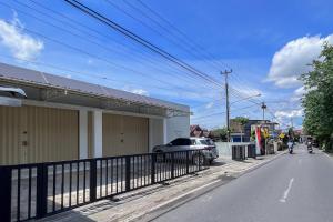 a car parked on the side of a street at RedDoorz Syariah Omah Audrey near RSI Kota Magelang in Kedungsari +21 photos