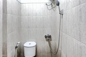 a bathroom with a shower with a toilet in it at RedDoorz Syariah Omah Audrey near RSI Kota Magelang in Kedungsari