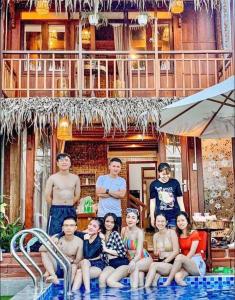 a group of people sitting in a swimming pool at Family Tan Thanh in Tân Thành (1)