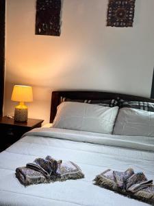 a bed with two towels sitting on top of it at Sala Homestay in Ban Mae Nai