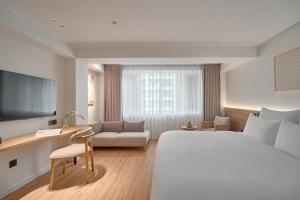 a hotel room with a bed and a desk at Amaya Saigon Boutique Hotel in Ho Chi Minh City +67 photos