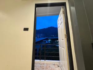 an open door with a view of a balcony at Chapter 26 in Patong Beach +9 photos