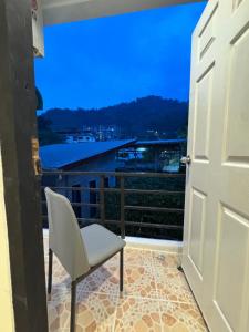 a door leading to a balcony with a chair at Chapter 26 in Patong Beach