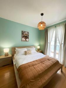 a bedroom with a large bed and a large window at Kotor Vista Seaview 2 apartment by MN Property in Muo