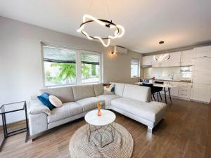 a living room with a couch and a table at Kotor Vista Seaview 2 apartment by MN Property in Muo