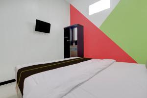 Μια τηλεόραση ή/και κέντρο ψυχαγωγίας στο Hotel O Mirza Guesthouse Syariah