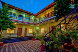 a house with a courtyard with plants in it at Maya Beach Resort Near Vagator Petrol Pump Anjuna in Vagator