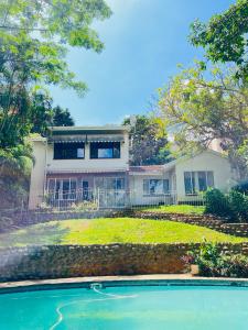 a house with a swimming pool in front of it at LaPoch Guesthouse in Durban