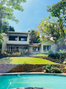 a house with a swimming pool in front of it at LaPoch Guesthouse in Durban