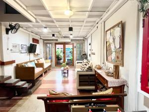 a living room with a couch and a table at WiNNiNE Cozy Home in Bangkok