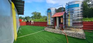 two wine tanks on a patio with green grass at Banana Bar in San Juan