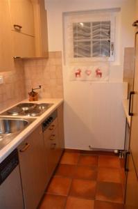 a small kitchen with a sink and a window at Chalet Ariane in Blatten bei Naters