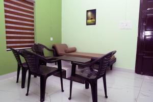 a table and chairs in a room with an american flag at The Arena Edava in Paravūr