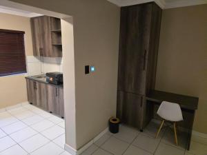 a kitchen with a counter and a chair in it at La Majestic Guest Lodge in Centurion +30 photos