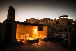 a room with a couch and a table in front of a building at Siwa Villa in Siwa
