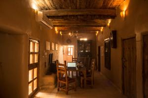 a dining room with a table with a laptop on it at Siwa Villa in Siwa
