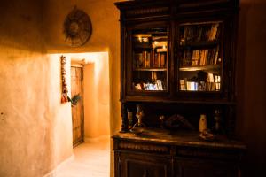 a wooden cabinet with books on it in a room at Siwa Villa in Siwa
