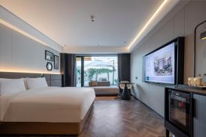 TV a/nebo společenská místnost v ubytování Meilun Hotel, Longhu Financial Island, Zhengzhou