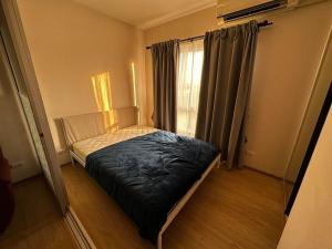 a small bed in a room with a window at Plum condo Bang-yai station in Nonthaburi +9 photos