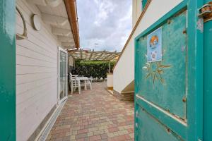 an open door to a patio with a table at Azure Oasis with parking near the airport & beach in Focene