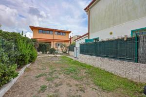 an empty yard in front of a building at Azure Oasis with parking near the airport & beach in Focene +38 photos