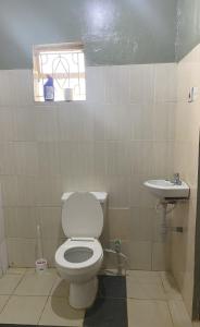 a bathroom with a toilet and a sink at EKO Holiday Homes, Lake Chala in Taveta