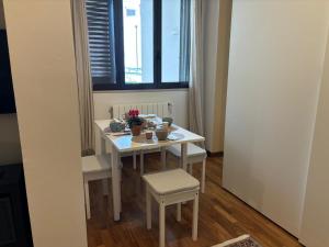 a small white table and chairs in a room with a window at AGAVE Suite in Lecce +25 photos
