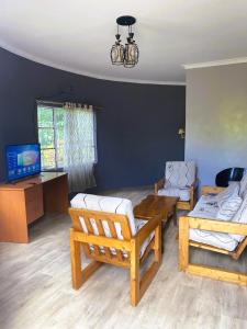 a living room with a couch and a table at EKO Holiday Homes, Lake Chala in Taveta