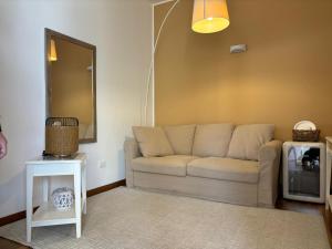 a living room with a couch and a mirror at AGAVE Suite in Lecce