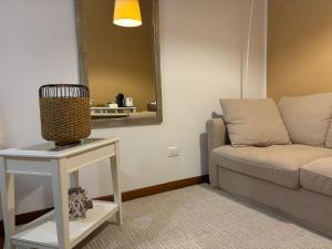 a living room with a couch and a table with a mirror at AGAVE Suite in Lecce