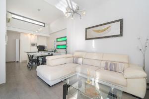 a living room with a couch and a table at Villa La Finca Golf in Algorfa