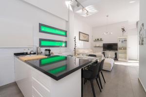 a kitchen with a counter top and a living room at Villa La Finca Golf in Algorfa