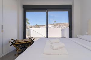 a bedroom with a large white bed and a large window at Villa La Finca Golf in Algorfa +24 photos