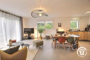 a living room with a table and chairs at Loguel an placen in Saint-Laurent