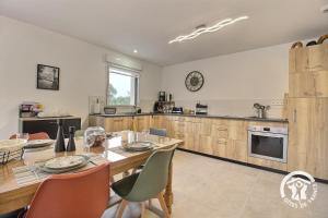 a kitchen with a table and chairs and a dining room at Loguel an placen in Saint-Laurent