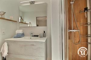 a bathroom with a sink and a mirror at Loguel an placen in Saint-Laurent +32 photos