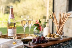 a table with a bottle of wine and glasses at Landal Hexham Lodges in Slaley