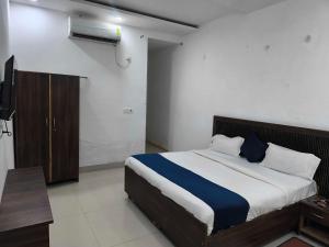a bedroom with a bed and a television in it at Hotel O Sector 110 Noida Formerly Luv Kush Tower Bhangel in Noida +16 photos