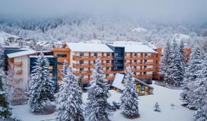 an aerial view of a hotel in the snow at Bakuriani Inn in Bakuriani