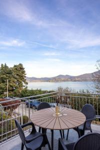 einen Tisch und Stühle auf einem Balkon mit Seeblick in der Unterkunft Profumo di LAGO - Il Lago incontra la tranquillità in Oggebio