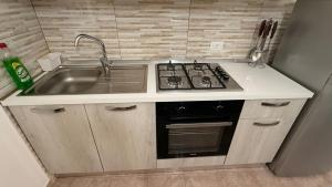 a kitchen with a sink and a stove at Loft Plaesano in Plaesano