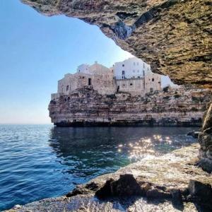a view of a castle on a cliff over the water at dimora princ di napoli 14 in Polignano a Mare