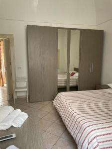a bedroom with a bed and cabinets and a bedroom with a bed at dimora princ di napoli 14 in Polignano a Mare