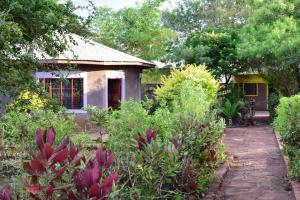 a house in the middle of a garden at EKO Holiday Homes, Lake Chala in Taveta