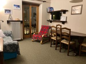 a living room with chairs and a table and a window at mountain summit sestriere in Sestriere