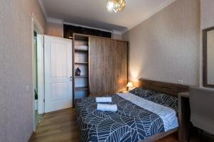 a bedroom with a bed and a book shelf at Luxury 2 Bedrooms Apartment with 2 bathrooms & Batumi center in Batumi