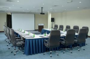 a conference room with a long table and chairs at Montrose - A Mayfair Collection Hotel in Kuwait +47 photos