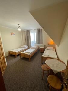 Ένα ή περισσότερα κρεβάτια σε δωμάτιο στο Pokoje gościnne Andrzej Brynkus