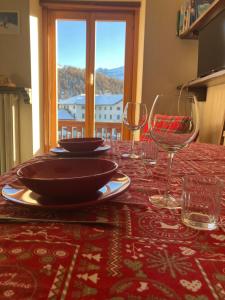 a table with plates and wine glasses on a table at mountain summit sestriere in Sestriere
