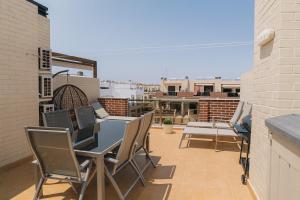 a patio with a table and chairs on a balcony at 3 bedroom, two-level, morden apartment in Orihuela Costa